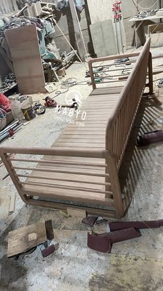 a wooden bench sitting on top of a dirty floor