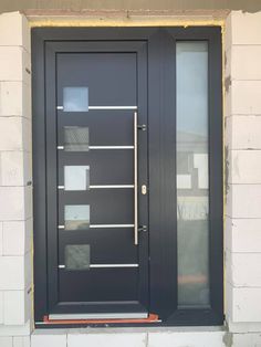 a black front door with glass and metal bars