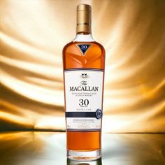 a bottle of macallan 30 year old single cask whisky on a shiny surface