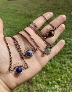 a person holding out their hand with five different jewelry pieces on it's palm