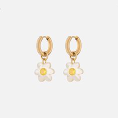 The NOTTE Mini Super Bloom Earrings are inspired by childhood memories and feature nostalgic whimsical design details. These happy little earrings will keep you smiling wherever you go. Hand- carved mother of pearl inlaid with zirconia gems, tarnish-resistant thick gold plated hoops Handmade or natural materials mean no two are identical. Minor variations make each piece special! Sold as a pair White Gold Plated Tarnish Resistant Earrings, White Drop Huggie Earrings, White Gold-plated Huggie Earrings, Trendy White Gold Plated Earrings, Huggie Earrings With Flower Charm For Gift, White Huggie Earrings As Gift, Super Bloom, Melissa Joy Manning, Ear Stack