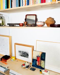 there are many books on the shelves in this room, and one is holding pictures