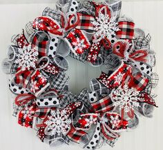 a red and black wreath with snowflakes on it