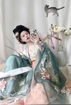 For the spring fairy, this gorgeous Tang Dynasty inspired set is adorned head to toe with embroideries of lotuses, mandalas and peacock feathers. Not one corner is neglected! From the wrists to the back, envelop yourself in the luxuries of high quality flowers. The Daxiushan (大袖衫, wide sleeved jacket) is dramatic and elegant, creating movement and grace with its exaggerated sleeves. Layer the embroidered jacket over the sheer jacket for a dimensional effect. The star of the show is the Heziqun ( Spring Wedding Kimono With Floral Embroidery, Traditional Spring Wedding Kimono, Lotus Fairy, Modern Hanfu, History Taking, Spring Fairy, Sheer Jacket, Exaggerated Sleeves, Tang Dynasty