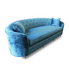 a blue couch with two pillows on it's back and one arm folded up