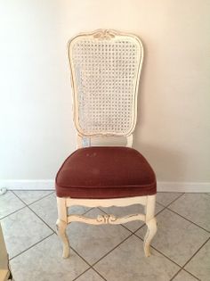 a white chair sitting on top of a tile floor next to a wall and tiled floor