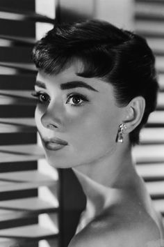 a black and white photo of a woman with short hair