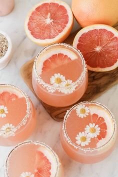 grapefruit margaritas are garnished with flowers and sprinkles