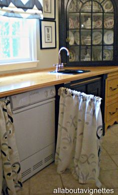 a kitchen with a sink, dishwasher and window