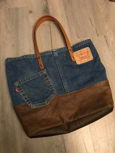 a brown and blue purse sitting on top of a wooden floor