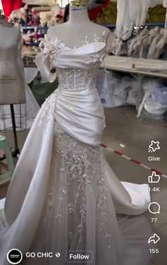 a white wedding dress on display in a store