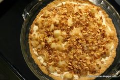 a pie with nuts on top in a glass dish