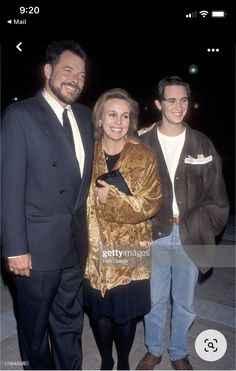 two men and a woman standing next to each other