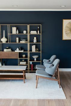 a living room with blue walls and furniture