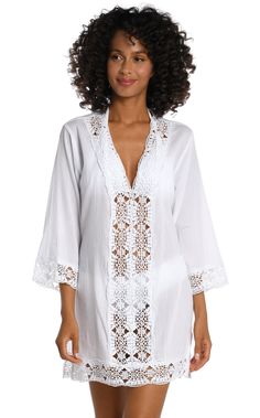 Sweetly sophisticated, this solid tunic offers just the right amount of coverage with a crocheted center panel in front to offer a glimpse of your swimsuit underneath. Crocheted trim around the neck, cuffs and hem gives this post-dip cover-up an effortless elegance that takes you from beach to brunch in style. [split] Details V-neck tunic 3/4-length sleeves Crocheted trim Lightweight fabric Breezy silhouette Fabric Elegant Long Sleeve Swimwear For The Beach, Beachwear Tops With Crochet Trim For Beach Cover-up, Summer Split Neck Top For Beach, Casual Lace Trim Cover-up, Chic Beach Tops With Crochet Trim, V-neck Tops With Crochet Trim For Beach, Vacation Swimwear With Crochet Trim And Stretch, Fitted Lace Trim Beach Cover-up, Stretch Swimwear With Crochet Trim