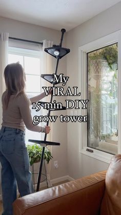 a woman standing in front of a window with the words, my virtual is mm diy grow tower