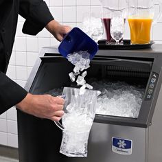 a man is pouring ice into a cooler