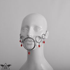 'DRIBBLE' mask in red. The rings and hoops across the cheeks meet in a large ring around the mouth. Fastening with chain adjuster at the back. 1-4 weeks to make and ship + transit time, or select 'rushed' to make and ship within 1 week (+ transit time, depending on shipping method). Adjustable Red Masks And Prosthetics For Masquerade, Costume Masks, Costume Mask, Large Ring, The Rings, Costume Accessories, Hoop Earrings, Style Inspiration, Mask