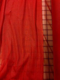 red sheer fabric with checkered squares on it