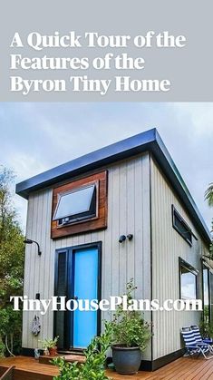 a tiny house with a blue door and steps leading up to the front porch area