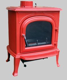 an old fashioned red stove with the door open