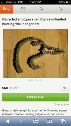 an image of a green and black snake on a wooden floor with the caption saying, recycled shorn shell ducks unlimted hunting wall hanger art add to cart