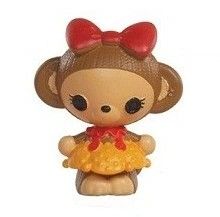 a small toy with a red bow on it's head and hair in the shape of a monkey