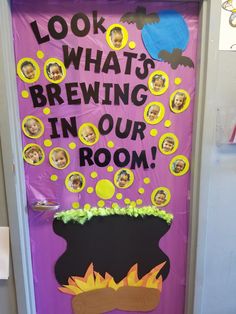 a door decorated to look like a pot with fire inside and saying, look what's brewing in our room