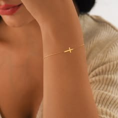 "Introducing our 14K Solid Gold Sideways Cross Bracelet - a pure testament to faith and elegance combined. This isn't just a coating; our bracelet is crafted entirely from genuine, solid 14K gold, ensuring lasting quality without the worry of wear or fading. Exuding both religious significance and subtle beauty, this piece resonates with Catholic traditions and serves as a graceful reminder of faith. Whether you're gifting it as a heartfelt Christmas present for a special woman in your life or wearing it as a personal emblem of devotion, this bracelet is a timeless treasure for any occasion.  PRODUCT DETAILS:  * Material: 14K Solid Gold (real solid gold, no gold-filled or no gold plated material)  * Choice of Gold Color: Yellow Gold, Rose Gold, White Gold  * Bracelet Length: 7 inches (exte Minimalist Gold Rosary Bracelet Gift, Gold Cross Bracelets For Gifts, Handmade Gold Cross Bracelets, Elegant Yellow Gold Cross Rosary Bracelet, Christian Jewelry For Women, Location Names, Gold Cross-shaped Beaded Bracelets For Gifts, Gold Cross Bracelet, Catholic Traditions