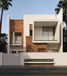 an apartment building with palm trees in the background