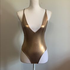 V- Neck Metallic Gold Body Suit, Closure At The Bottom, Low Back, Cross Cross Straps In The Back Chic Gold Swimwear For Summer, Elegant Gold Stretch Swimwear, Chic Gold Stretch Swimwear, Chic Gold Swimwear For Night Out, Elegant Metallic Swimwear, Elegant Gold Swimwear, Gold Fitted Sleeveless Swimwear, Fitted Gold Sleeveless Swimwear, Fitted Sleeveless Gold Swimwear