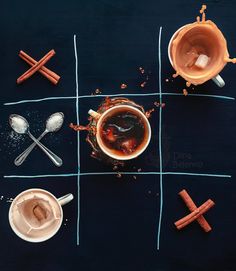 four cups of coffee with spoons and sugar on the side, arranged in a grid