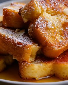 pieces of french toast on a plate covered in powdered sugar