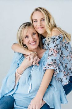 two women hugging each other and smiling