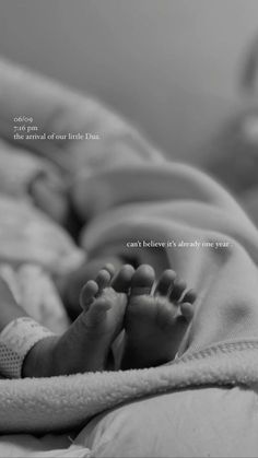 a black and white photo of a baby's feet