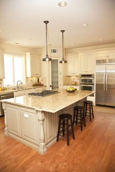 a large kitchen with an island in the middle