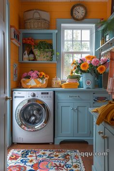 a washer and dryer in a small room with orange flowers on the window sill