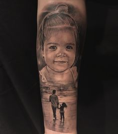 a woman's arm with an image of a child and her mother on it