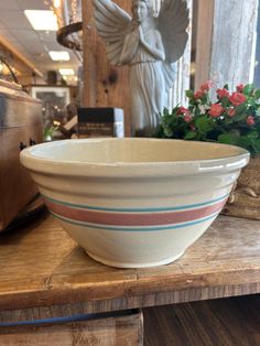 a white bowl sitting on top of a wooden table