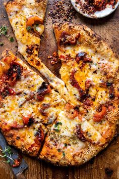 two slices of pizza on a wooden cutting board