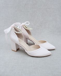 "Classic and elegant lace almond toe block heels with pearl ankle straps. Perfect for weddings, parties, or any special occasion. DETAILS: HEEL HEIGHT: 3 inches COLORS AVAILABLE: Ivory, White, Light Blue, Dusty Pink, Champagne, Burgundy, Navy and Black UPPER: Synthetic upper and lining MATERIALS: Mandmade outsole STYLE NAME: SALLY Not sure of which size to purchase? Shoes measurements are as follow: (Please note measurements taken the length of inside of shoe from toe to heel). Size 5 - 9.25\" S Elegant Almond Toe Heels For Bridesmaid, Elegant Low Heel Bridesmaid Heels, Feminine Wedding Shoes With Heel Strap, Elegant Pink Closed Toe Block Heels, Elegant Pink Pointed Toe Block Heels, Pink Elegant Block Heels For Formal Occasions, Elegant Pink Block Heels For Formal Occasions, Elegant Block Heels For Bridesmaids, Elegant Pink Block Heels