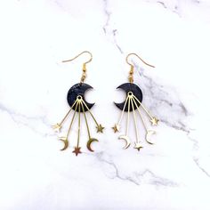 Dance with the Stars: Black & Gold Moon Wire Hook Earrings (Gift for Her) ✨Embrace the celestial spirit with these enchanting Black & Gold Moon Wire Hook Earrings! A captivating addition to your jewelry collection, this pair features a pair of black crescent moons adorned with shimmering gold accents.A perfect gift for the mystical woman in your life, these earrings embody the beauty and intrigue of the night sky. The lightweight design and comfortable hook closure with push backs ensure comfort Moon Phase Star Earrings For Gift, Celestial Black Metal Jewelry, Celestial Adjustable Pierced Earrings, Handmade Black Moon-shaped Earrings, Handmade Black Moon Earrings, Black Celestial Earrings For Gift, Handmade Black Crescent Earrings, Mystical Black Metal Earrings, Black Drop Earrings With Moon Charm