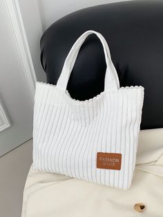 Add a touch of sophistication and functionality to your wardrobe with our Style Corduroy Tote Bag. Combining chic design with spacious interior, this bag is perfect for all your daily essentials. Its casual style makes it versatile for any occasion. Elevate your fashion game with this must-have accessory. Color : White Strap Type : Double Handle Style : Preppy Bag Size : Small Type : Shoulder Tote Bag Pattern Type : Plain Closure Type : Magnet Magnetic : Yes Material : Canvas Composition : 100% Linen Bag Height Bag Length Bag Width 23 32 7 Corduroy Bags With Zipper Closure, Chic Cotton Shoulder Bag For Daily Use, Spring Cotton Bags For Errands, Chic Cotton Bag With Large Capacity, Trendy Cotton Bag With Double Handles, Casual Corduroy Bag With Zipper Closure, Chic Large Capacity Cotton Bag, Trendy Everyday Corduroy Bag, Trendy Corduroy Everyday Bag