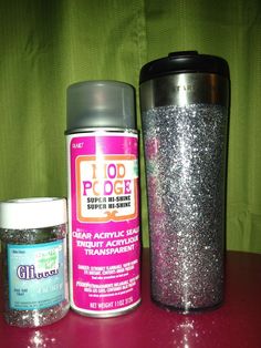 the contents of a travel mug and other items on a red counter top with green curtains in the background