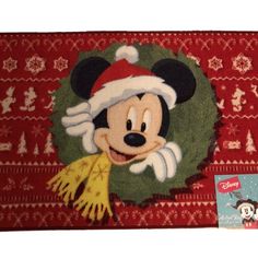 a mickey mouse rug with a christmas wreath on it