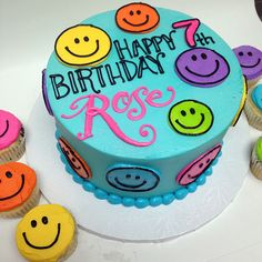 a birthday cake decorated with colorful smiley faces