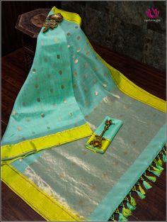 Chanderi saree in teal green with neon green border is a stunning combination. Teal green is a rich, elegant color that complements various skin tones, and the golden buttas spread across the body add a touch of traditional opulence. The neon green border provides a striking contrast, infusing a modern and vibrant feel into the classic Chanderi weave. Overall, this saree is a unique blend of classic craftsmanship and contemporary aesthetics, perfect for special occasions or cultural events. Fall and Pico - Done. Blouse - Unstitched. Custom fancy tassels. Please note: Color may vary slightly from the picture. Thread knots, thread pulls and minor inconsistencies are characteristic in Natural fiber sarees like cotton and it is not a defect.