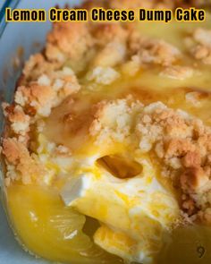 a lemon cream cheese dump cake in a glass dish with crumbs on top