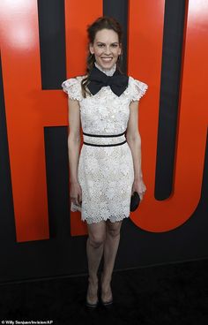 a woman in a white dress and black bow tie at the premiere of orange is the new black