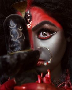 a woman with red makeup holding a knife